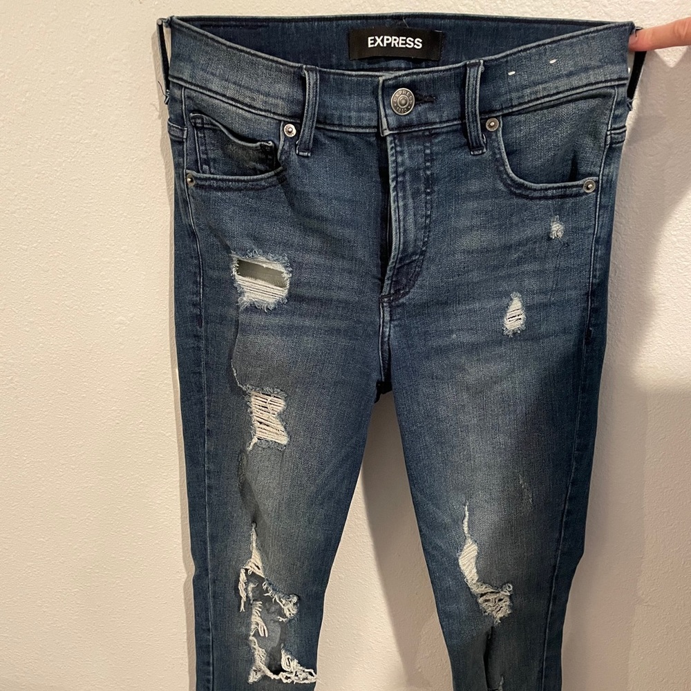 Boot cut distressed jeans.